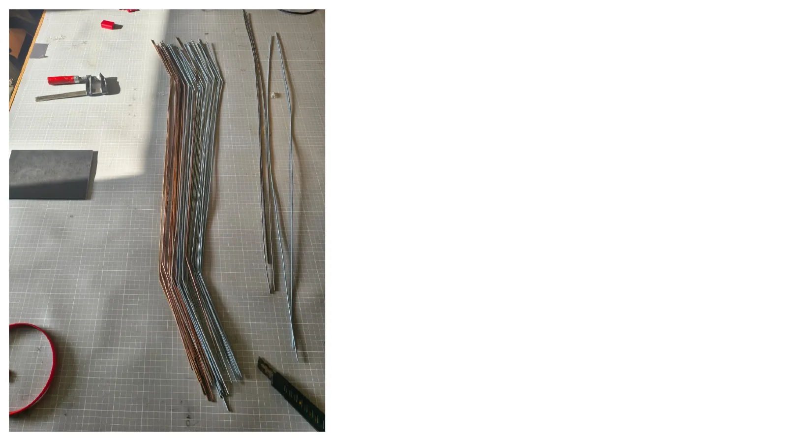 Photograph of bundled metal rods and string prepared for assembly