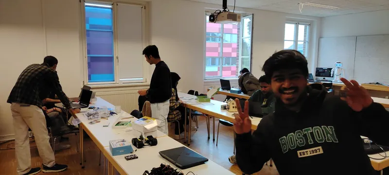 Students at laptops with robot kits in a TH OWL studio during the workshop